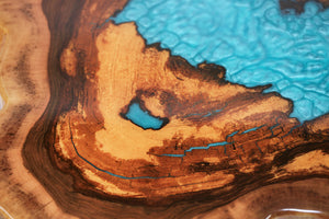 Round sliced walnut resin coffee table with unique cracks and holes inlays in turquoise colour