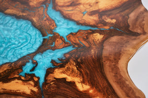 Round sliced walnut resin coffee table with unique cracks and holes inlays in turquoise colour