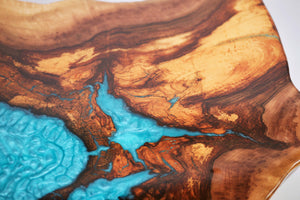 Round sliced walnut resin coffee table with unique cracks and holes inlays in turquoise colour